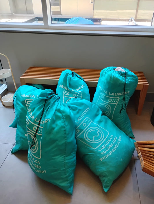 LABADA laundry bags filled with spa towels and robes inside a North Vancouver spa